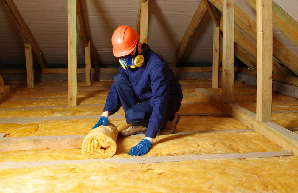 attic projects professional installing insulation in an attic