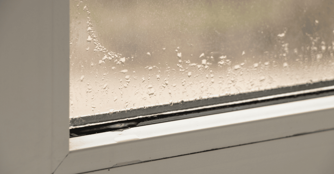 Excess moisture causes liquid to accumulate on a window.